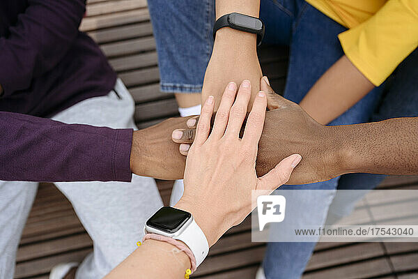 Multiracial friends doing hands stack