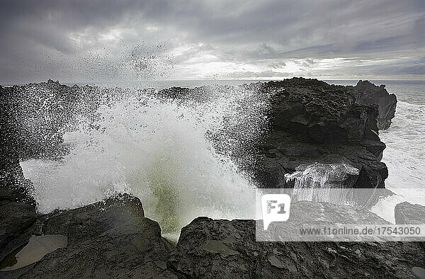 High tide waves splashing on rocks at Ponta da Ferraria  San Miguel  Azores  Portugal