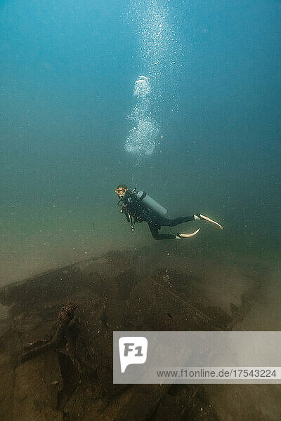 Scuba diver diving undersea at Del Coco beach