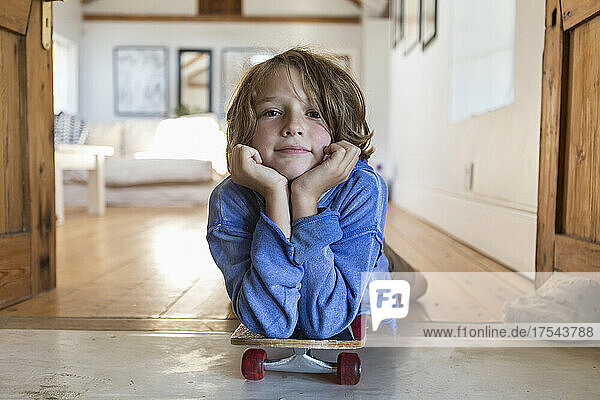 portrait of 8 year old boy with skateboard