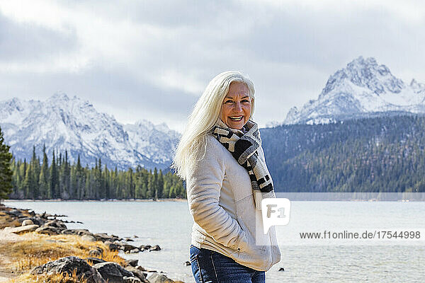 USA  Idaho  Stanley  Portrait of smiling senior woman at mountain lake
