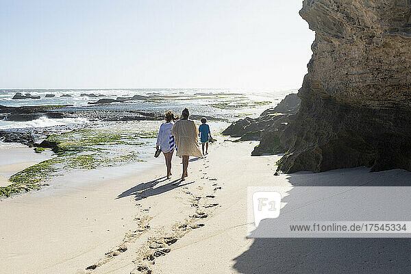 South Africa  Western Cape  Mother with boy (8-9) and girl (16-17) walking on beach in Lekkerwater Nature Reserve