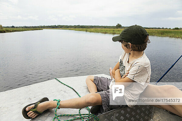 Africa  Zambia  Boy (8-9) in boat on Zambezi River near Tongabezi River Lodge
