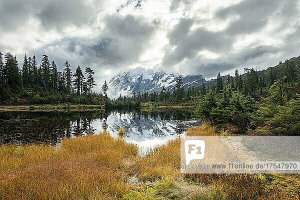 Mt. Shuksan in clouds  glacier with snow with reflection in Picture Lake  forested mountain landscape in autumn  Mt. Baker-Snoqualmie National Forest  Washington  USA  North America
