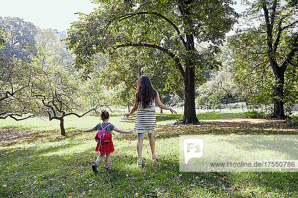 USA  New York  New York City  Rear view of mother and daughter (2-3) playing in park