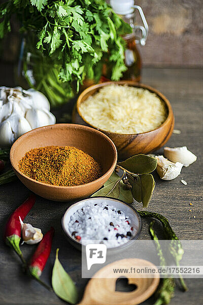 Traditional georgian spice for cooking pilaf in a bowl near by rice bowl on wooden table