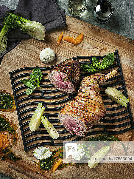 A grilled leg of lamb with fennel and pesto