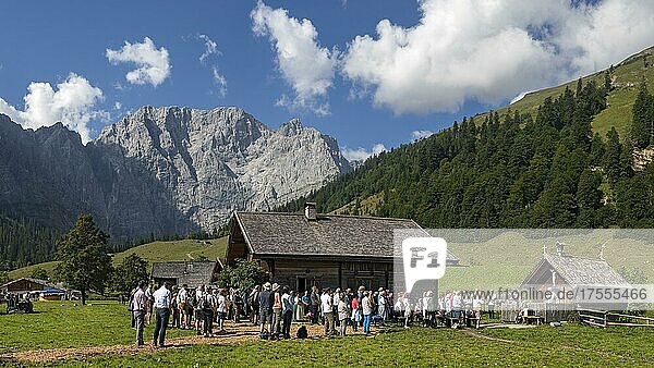 Mass celebration on Almkirtag in front of the wooden chapel in the alpine village of Eng  with Grubenkarspitze and Dreizinkenspitze in the background  Karwendel Mountains  Hinterriss  Tyrol  Austria  Europe