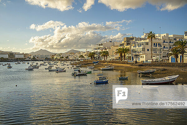 View of boats on beach in Baha de Arrecife Marina surrounded by shops  bars and restaurants at sunset  Arrecife  Lanzarote  Canary Islands  Spain  Atlantic  Europe