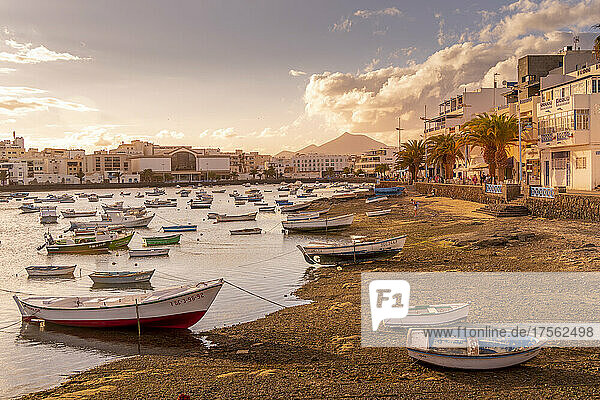 View of boats on beach in Baha de Arrecife Marina surrounded by shops  bars and restaurants at sunset  Arrecife  Lanzarote  Canary Islands  Spain  Atlantic  Europe