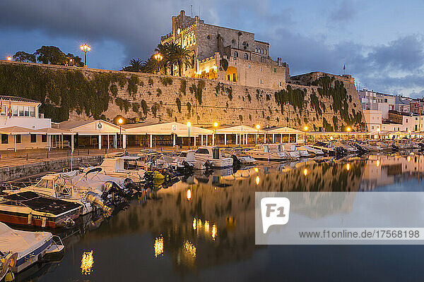 Blick über den ruhigen Hafen auf das beleuchtete Rathaus in der Abenddämmerung  Ciutadella (Ciudadela)  Menorca  Balearische Inseln  Spanien  Mittelmeer  Europa