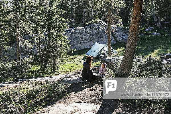 Mother and daughter resting near their camp in Colorado