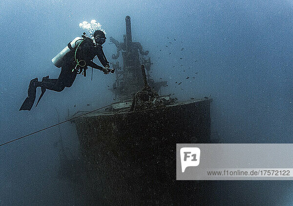 diver exploring the Sattakut wreck off the coast of Koh Tao