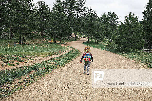 Girl hiking with a backpack at Mount Falcon Park