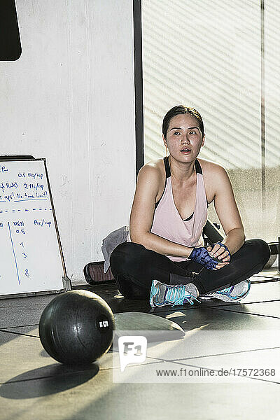 woman having a rest during workout at gym in Bangkok