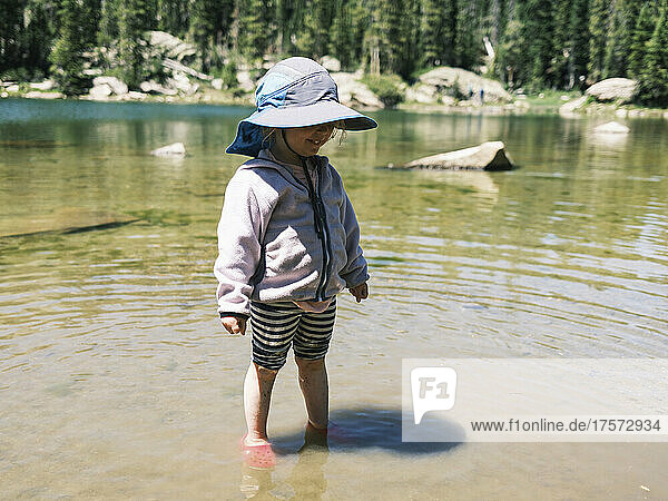 Girl standing in the shallow water of Brady Lake  Colorado