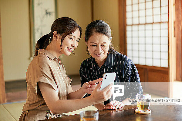 A Japanese Senior Woman Who Teaches Me How To Use A Smart Phone