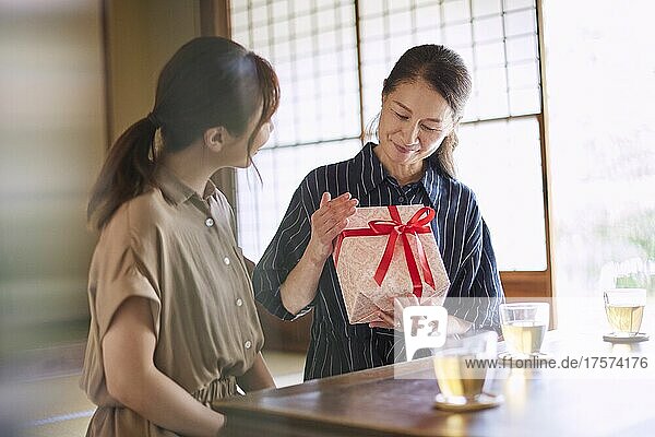 Japanese Senior Lady Receiving A Present