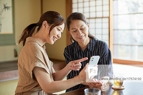 A Japanese Senior Woman Learning How To Use A Smart Phone