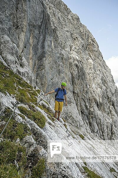 Young man climbing in via ferrata  hiking trail to Lamsenspitze  Karwendel Mountains  Alpenpark Karwendel  Tyrol  Austria  Europe