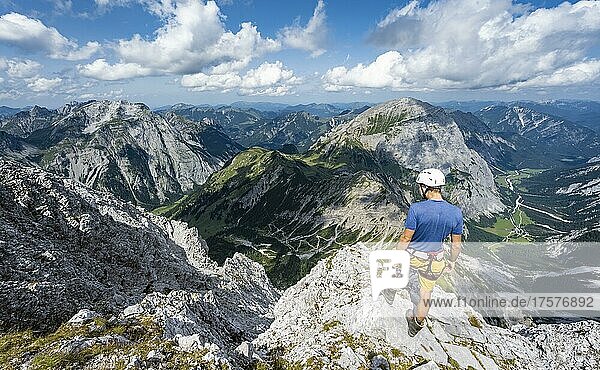 Hikers at the summit of the Lamsenspitze  view into the Falthurntal valley with Sonnjoch peak  Karwendel Mountains  Alpenpark Karwendel  Tyrol  Austria  Europe