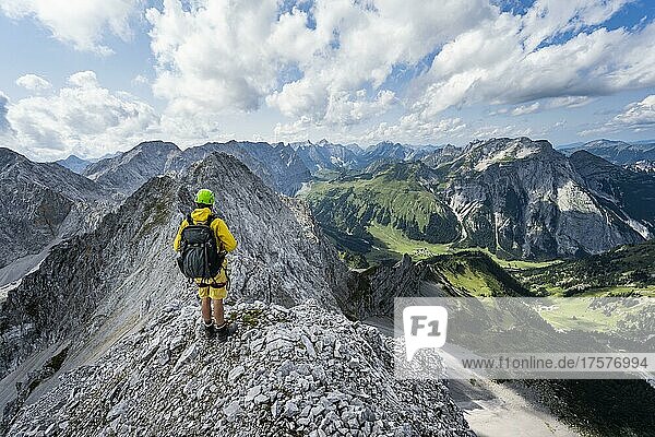 Hikers at the summit of the Lamsenspitze  view of the rocky ridge and summit of the Schafkarspitze  in the background Engtal and gamsjoch  Karwendel Mountains  Alpenpark Karwendel  Tyrol  Austria  Europe