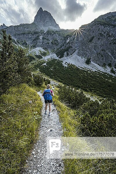 Sun star  hiker on the way to Lamsenspitze  Tyrol  Austria  Europe