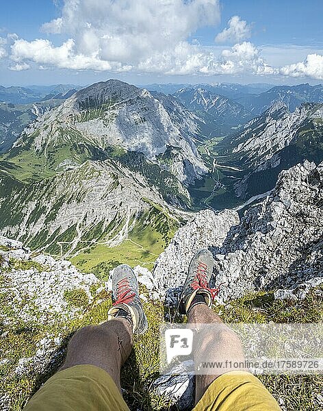 Mountain landscape  hiker lets his legs dangle  hiking boots and view from the Lamsenspitze to mountains and the Gramaital  Karwendel Mountains  Tyrol  Austria  Europe