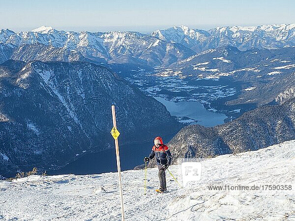 Snowshoe hiker on the Five Fingers trail in winter landscape  view of Lake Hallstatt  Krippenstein  Salzkammergut  Upper Austria  Austria  Europe