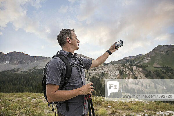 United States  Utah  Alpine  Male hiker photographing mountain landscape