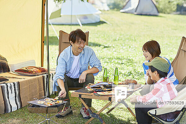 Japanese Family Talking At Campsite