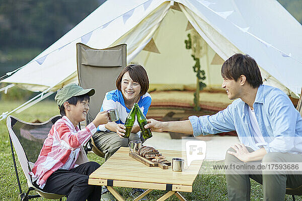 Japanese Family Toasting At Campsite