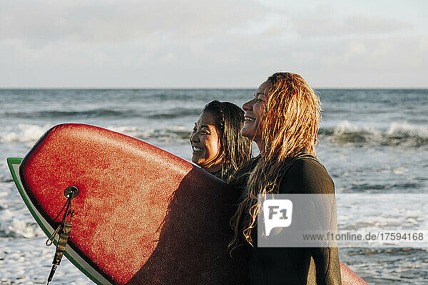 Happy women with surfboards at beach  Gran Canaria  Canary Islands