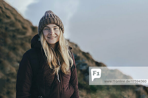 Smiling young tourist in knit hat at Caucasus Nature Reserve in Sochi  Russia