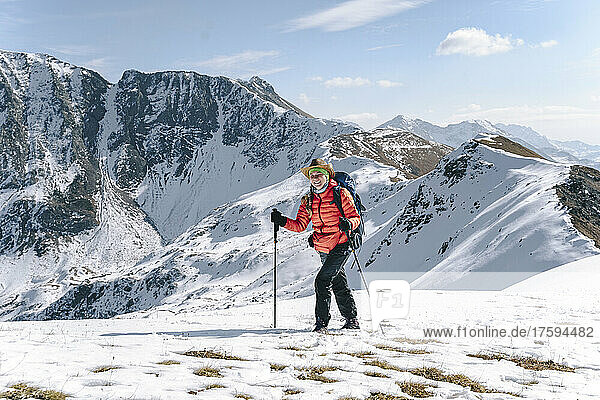 Happy woman hiking on snow covered mountain  Caucasus Nature Reserve  Sochi  Russia