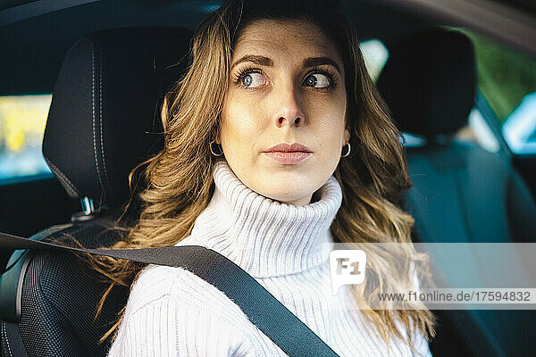 Contemplative woman in car