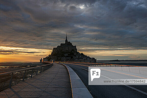 France  Normandy  Cloudy sky over bridge connecting Mont-Saint-Michel island at dusk