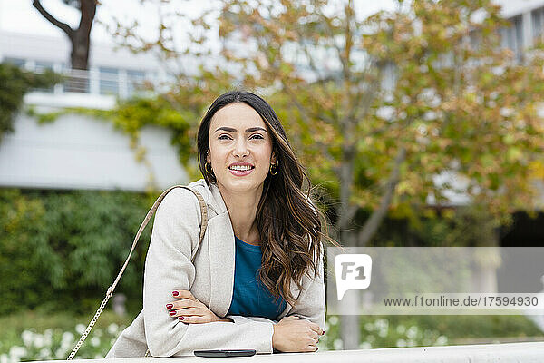 Smiling businesswoman in autumn park