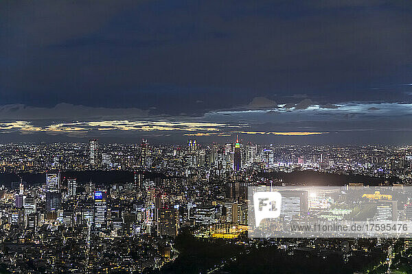 Japan  Kanto Region  Tokyo  Cloudy sky over illuminated city downtown at night