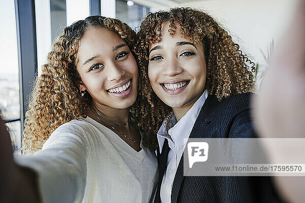 Businesswomen taking selfie in office