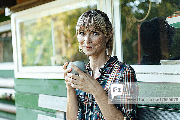 Woman having coffee in garden