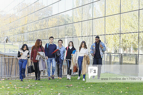Multiracial students walking on university campus