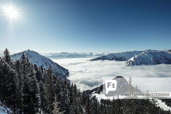 Rofan Mountains on sunny winter day with heavy fog over Achen Lake and Inntal