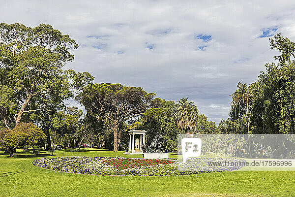 Australia,  South Australia,  Adelaide,  Flowerbed in Angas Gardens with Angas Family Memorial in background