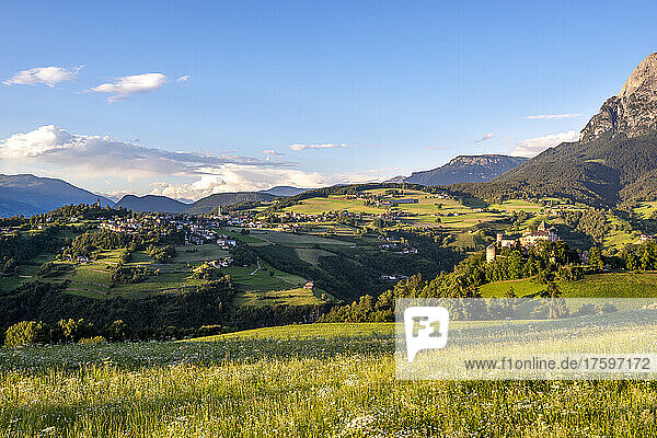 Italy  South Tyrol  Vols am Schlern  Alpine meadow in summer with village and Prosels Castle in background