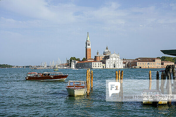 Italy  Veneto  Venice  Motorboats moored in marina with San Giorgio Maggiore island in background