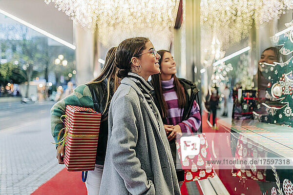 Young women window shopping at Christmas