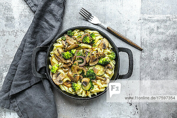 Penne pasta with mushrooms  broccoli  zucchini and onion
