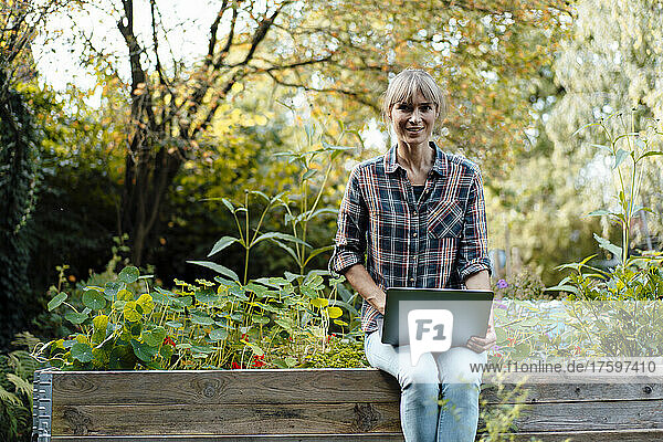 Woman with laptop in organic back yard