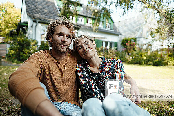 Smiling man and woman together in garden